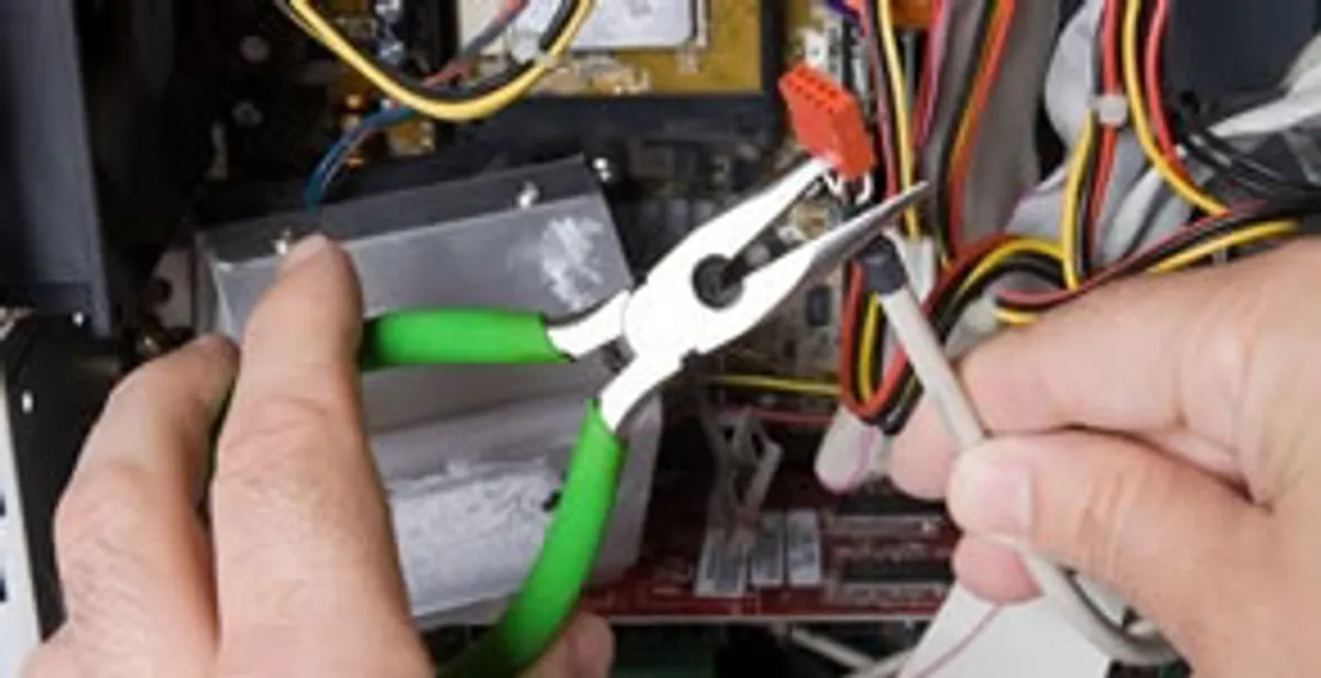 Licensed electrical contractor performing electrical repair with tools in Wheat Ridge, CO